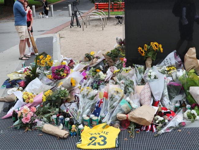 People laid flowers and other items at the statue of Shane Warne at the Melbourne Cricket Ground. Picture: NCA NewsWire / David Crosling