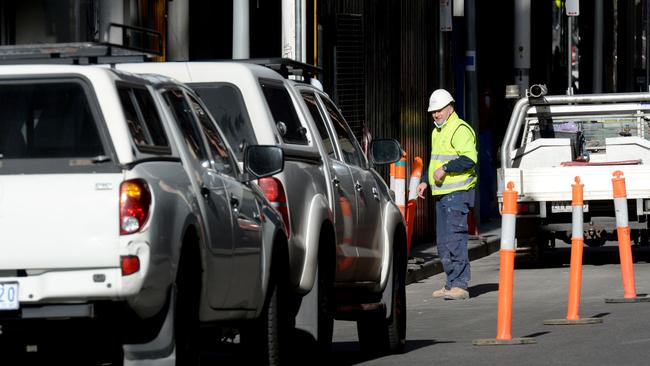 Builders' vehicles took up many of the city's parking spaces this morning as more tradies and workers associated with the construction industry were allowed to go back to work after Sunday's easing of Stage 4 restrictions. Picture: Andrew Henshaw