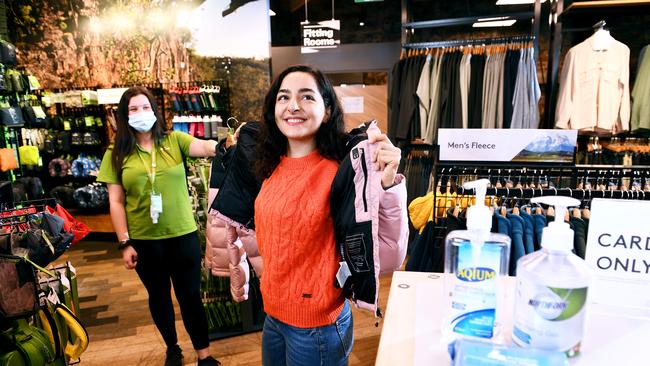 Customer Aysan Gholipoor tries on the latest women’s jacket watched by sales adviser Elysse Dimitriadis at Katmandu in Rundle Mall, Adelaide. Picture Mark Brake