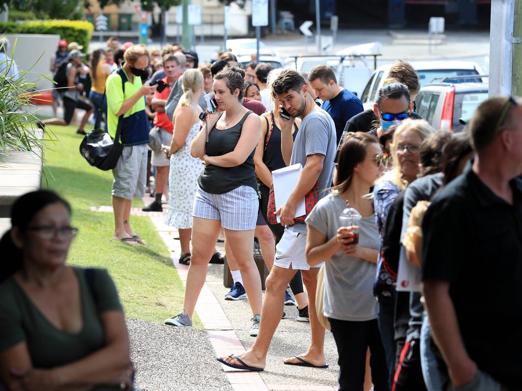 Lines of people wait at Southport Centrelink. Picture: Adam Head.