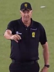 Umpire Greg Davidson raises the finger for a dismissal...