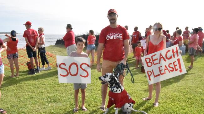 Thousands of protesters turned out at Stockton Beach including Nate Praden (7), Shay Walker and his Dalmatian Snoopy and Katherine Blow. Supplied.