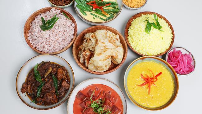 The chef’s choice menu featuring the negombo curry, coriander chicken, mild cashew curry, red lentil curry, aromatic rice, string hoppers, roti, cucumber curd and pickles at new Sri Lankan eatery Ra restaurant and bar. Picture Lachie Millard