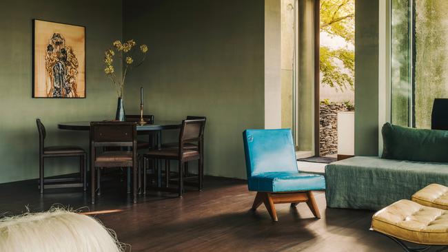 A sisal stool by Fernando Laposse (foreground) and a blue Pierre Jeanneret lounge chair in the family room of Boris Vervoordt’s loft near Antwerp, Belgium. The painting is by Ida Barbarigo. Picture: Salva López for WSJ. Magazine