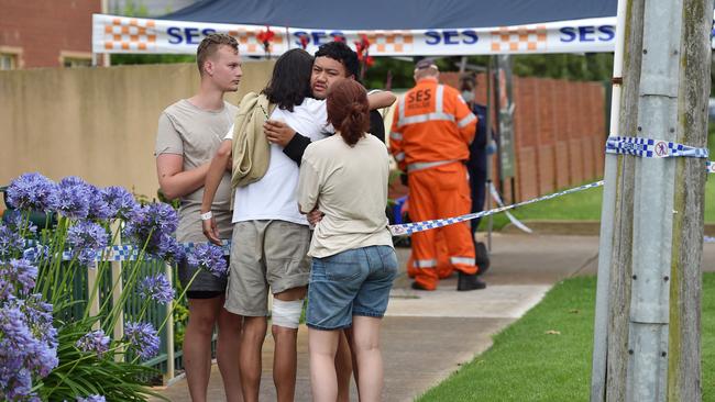 People embrace at the scene in Werribee South. Picture: Nicki Connolly