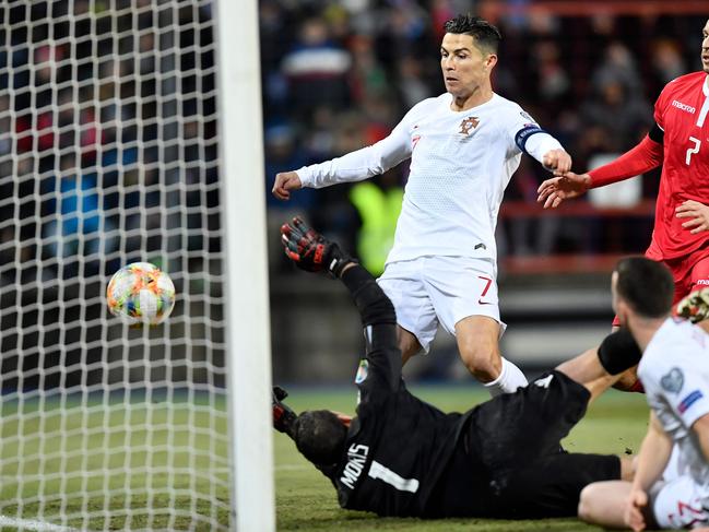 Portugal's forward Cristiano Ronaldo (C) scores a goal during the UEFA Euro 2020 Group B qualification football match between Luxembourg and Portugal at the Josy Barthel Stadium in Luxembourg on November 17, 2019. (Photo by JOHN THYS / AFP)