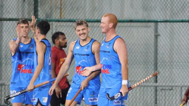 Luke Broadway (centre) celebrates a goal for the Territory Stingers. Picture: Hockey NT / Territory Stingers