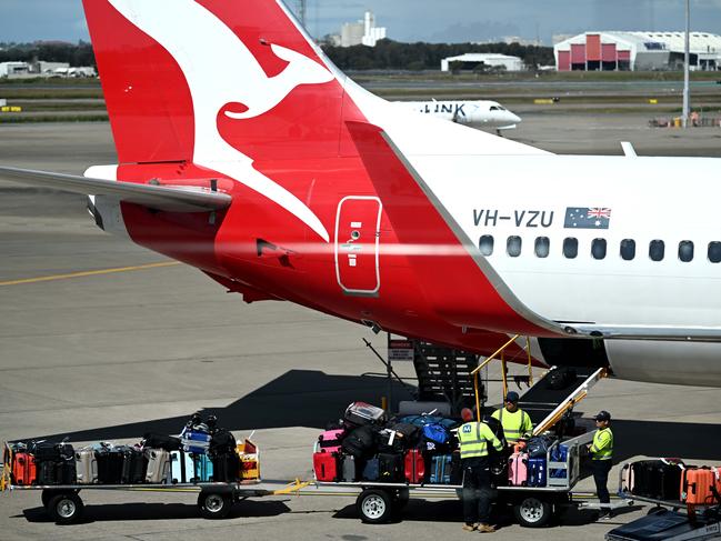 BRISBANE, AUSTRALIA - NewsWire Photos - AUGUST 11, 2022. Qantas baggage handlers at work at Brisbane airport. Industrial action will start at Qantas and budget offshoot Jetstar by the end of August amid an escalating fight over pay with its licensed engineers.Picture: NCA NewsWire / Dan Peled