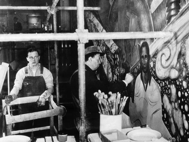 Diego Rivera working on his controversial mural at Rockefeller Centre in New York, with Hugh Curry Jr as his model. Picture: Getty Images