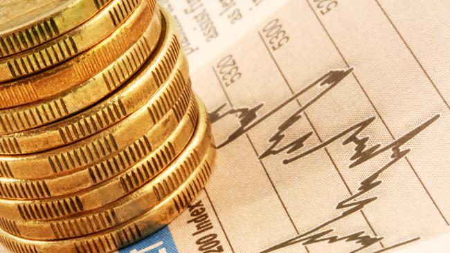 A stack of gold coins on a finance page stock market index graph. ASX investing Australian money generic