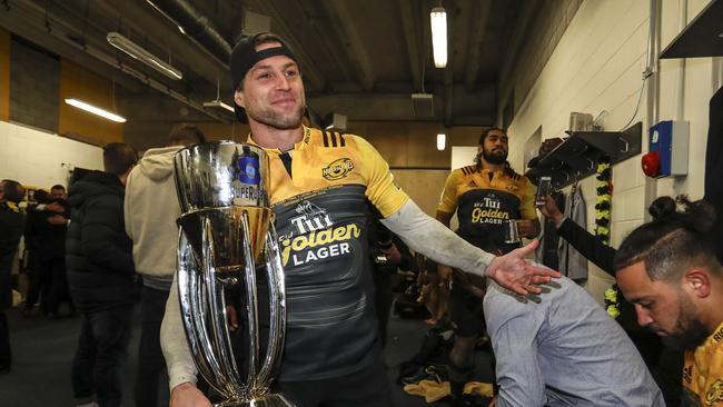 Cory Jane of the Hurricanes holds the Super Rugby trophy.