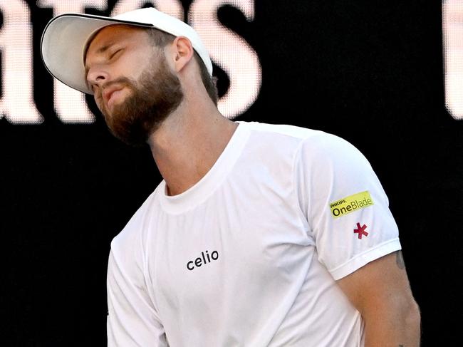 France's Corentin Moutet reacts on a point against USA's Learner Tien hits during their men's singles match on day seven of the Australian Open tennis tournament in Melbourne on January 18, 2025. (Photo by Paul Crock / AFP) / -- IMAGE RESTRICTED TO EDITORIAL USE - STRICTLY NO COMMERCIAL USE --