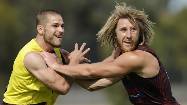 David Zaharikis and Dyson Heppell grapple at Essendon training.