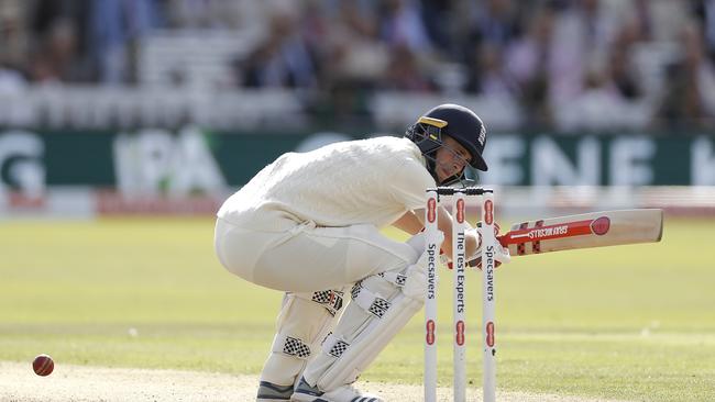 England allrounder Chris Woakes is struck on the helmet by a delivery from Pat Cummins. Picture: Getty Images