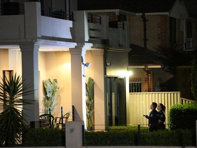 Police and forensics at the scene of the shooting in Merrylands. Picture: Steve Tyson