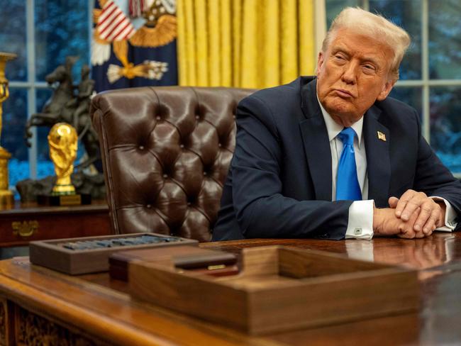 US President Donald Trump listens to Elon Musk speak in the Oval Office of the White House in Washington, DC, on February 11, 2025. Tech billionaire Elon Musk, who has been tapped by President Donald Trump to lead federal cost-cutting efforts, said the United States would go "bankrupt" without budget cuts. Musk leads the efforts under the newly created Department of Government Efficiency (DOGE), and was speaking at the White House with Trump, who has in recent weeks unleashed a flurry of orders aimed at slashing federal spending. (Photo by Jim WATSON / AFP)