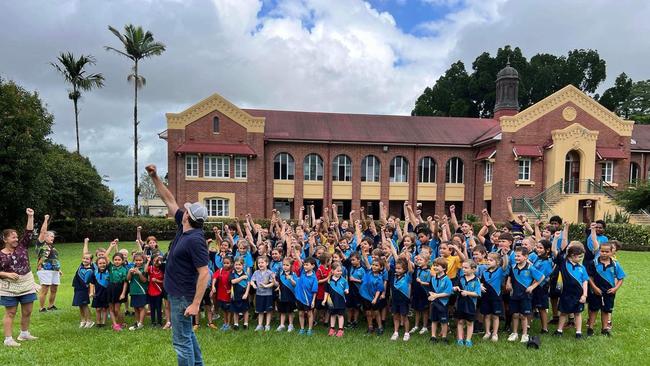 Australian country music star Josh Arnold and Tully State School students teamed up to create new song, 'Tumblin' Tully Rain' to celebrate the town's centenary. Photo: Facebook.