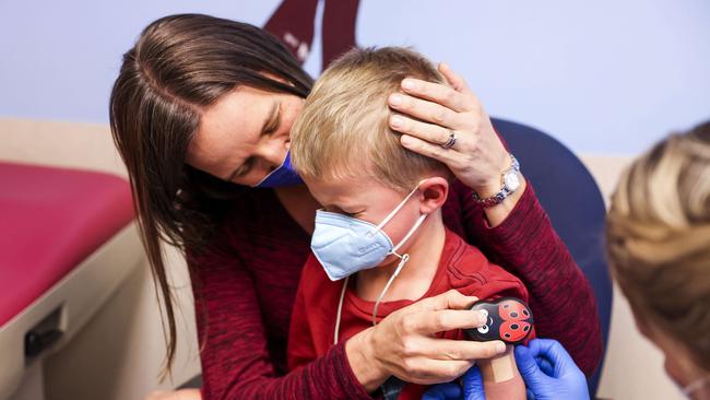 Jill Holm-Denoma comforts her son Tyler Holm-Denoma, 5, after receiving the Covid-19 vaccine. The US approved the vaccine for 5 to 11-year-olds. Picture: AFP.