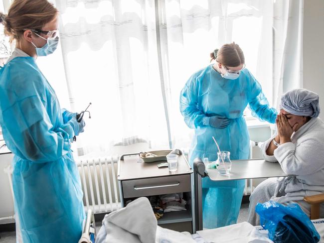 A COVID-19 infected patient gets treatment. Picture: AFP