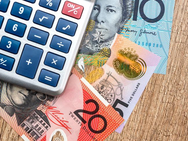 Australian dollar calculator on a wooden table. Generic money, investing, Australian notes