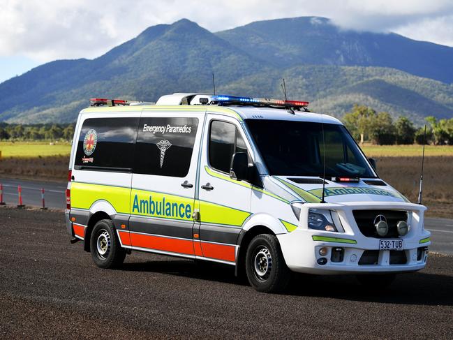 Emergency services attend a fatal car crash on the Bruce Highway, south of Townsville at Mount Surround. Garbage truck driver being looked over by paramedics.  Picture: Alix Sweeney