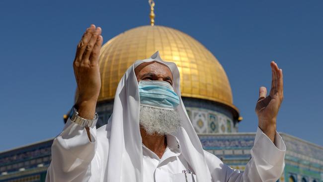 A Palestinian man prays in front of the Dome of the Rock mosque, in the Old City of Jerusalem. Picture: AFP