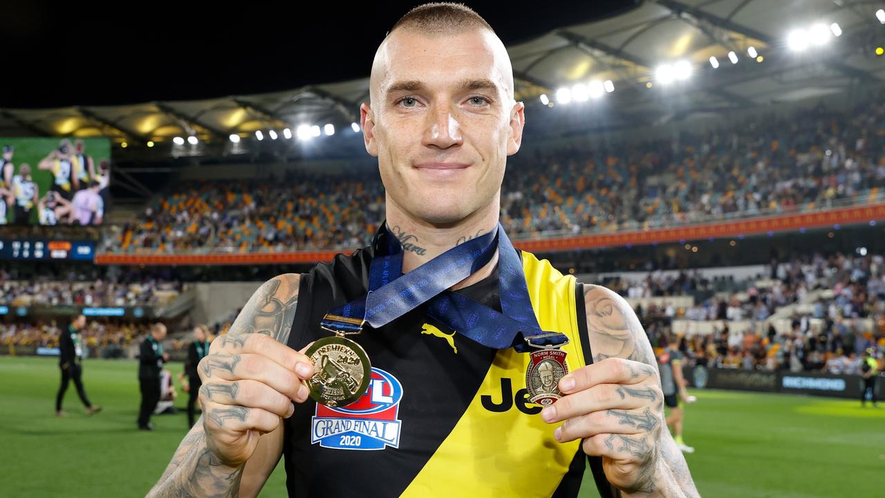 Dustin Martin celebrates with his third Norm Smith and premiership medals after the 2020 AFL grand final. Picture: Michael Wilson /AFL Photos via Getty Images