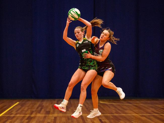 Cavaliers wing defence Asha Lowe and Cripps wing attack Maya Armstrong clash in the air in the U19 state netball grand final at Launceston's Silverdome. Picture: PATRICK GEE/SUPPLIED