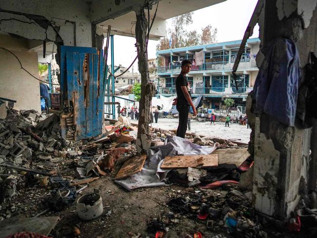 A Palestinian boy stands in a destroyed room a UN-school housing displaced people that was hit during Israeli bombardment in Nuseirat, in the central Gaza Strip. Picture: AFP