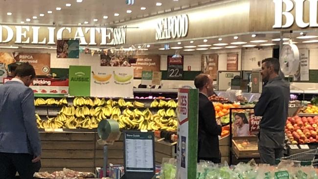 Police detectives investigate the supermarket where the apple was purchased. Picture: Jim O’Rourke