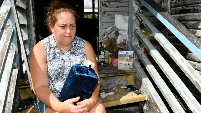 Christie Stonehouse holds the urn with her son's ashes at the Garbutt house where Ben was killed after a fire. Picture: Evan Morgan