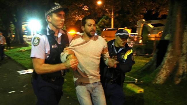 James Mathison being taken away by police after climbing a tree to be cut down for Sydney’s new trams. Picture: Dylan Robinson