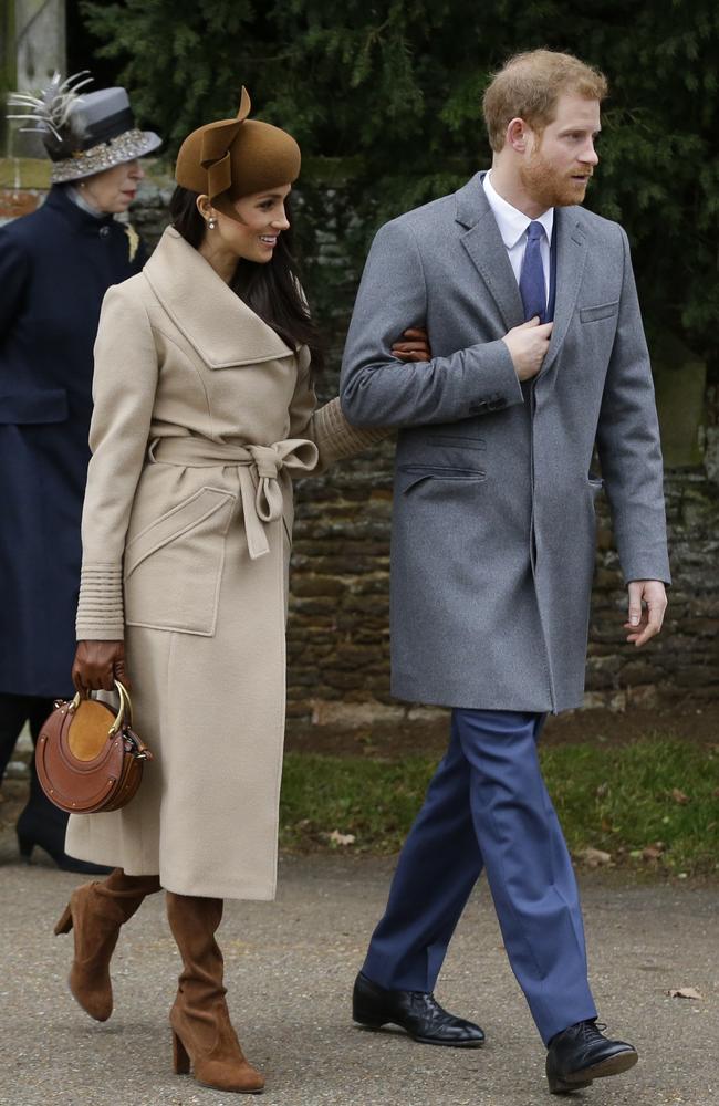 Britain's Prince Harry and his fiancee Meghan Markle walk towards members of the public to greet them following the traditional Christmas Day church service. Picture: AP