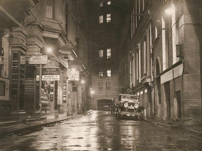 Sam Hood’s photo of Angel Place, Sydney, at night in the 1920s. The dimly lit lane was even darker before the coming of electric light in 1904. Picture: State Library of NSW