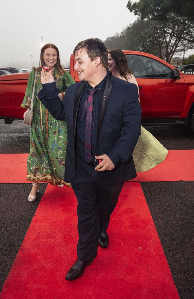 Graduate Jack Marshall with sisters Talia (left) and Renae Marshall at Clifford Park Special School formal at Clifford Park Racecourse, Wednesday, November 20, 2024. Picture: Kevin Farmer