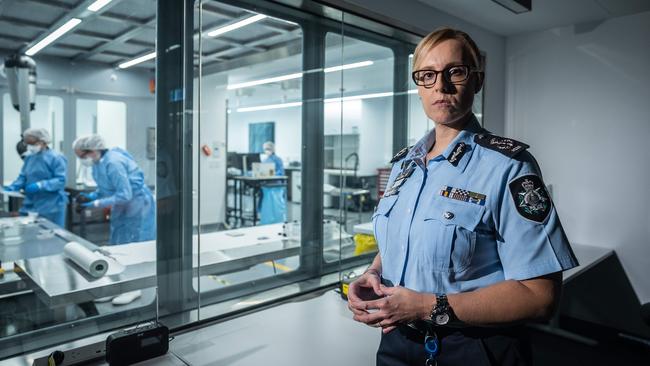 AFP Southern Command Assistant Commissioner Hilda Sirec looks on as members carry out work in a forensic lab. Picture: Jake Nowakowski