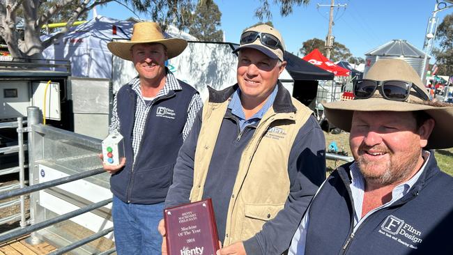 Bob Thornely (left) and Simon Flinn of Flinn Designs are congratulated by judge Warren Scheetz of Henty Machinery Field Days after Flinn Designs won the Machine of the Year with an automated catching pen. Picture: Nikki Reynolds