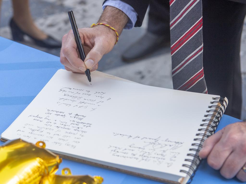 Premier Chris Minns writes in a condolence book on the one-year anniversary of the Westfield Bondi stabbing that killed 6 people. Picture: NewsWire / Jeremy Piper