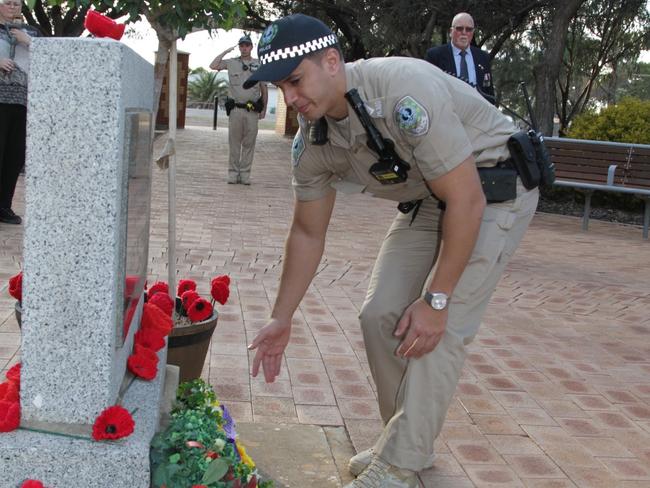 Brevet Sergeant Alex Chuykrom of Ceduna Police lays a wreath at the Ceduna RSL Cenotaph. Picture: Andrew brooks