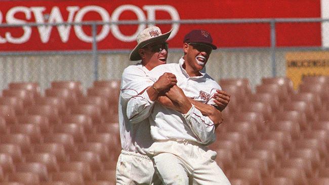 Brendan Creevey lifts Andrew Symonds from the ground celebrating the Qld shield win.