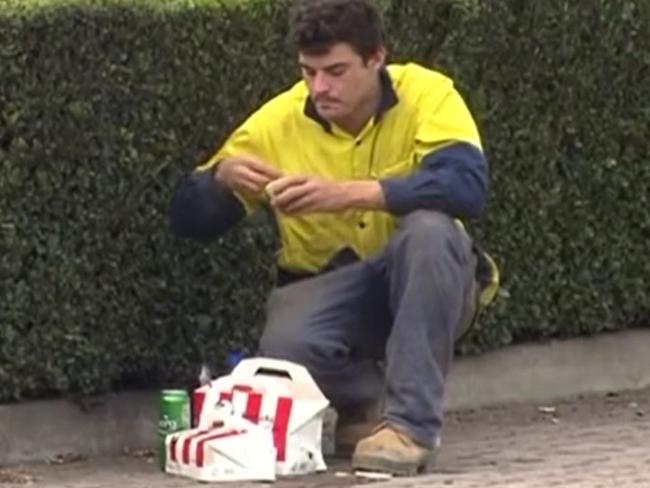 A tradie tucks into his KFC after crashing into a power pole near a drive-through in suburban Adelaide. Picture: 7NEWS