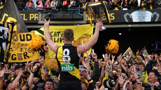 Jack Riewoldt holding the 2019 premiership cup in front of Richmond fans at the MCG. Picture: AAP