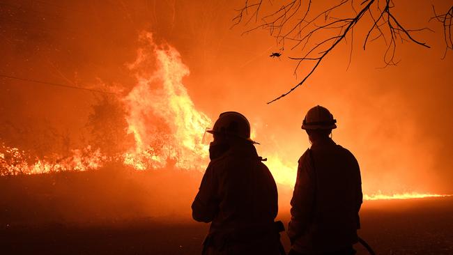 Firefighters protect properties as the Wrights Creek fire approaches in December. Picture: AAP Image/Dan Himbrechts