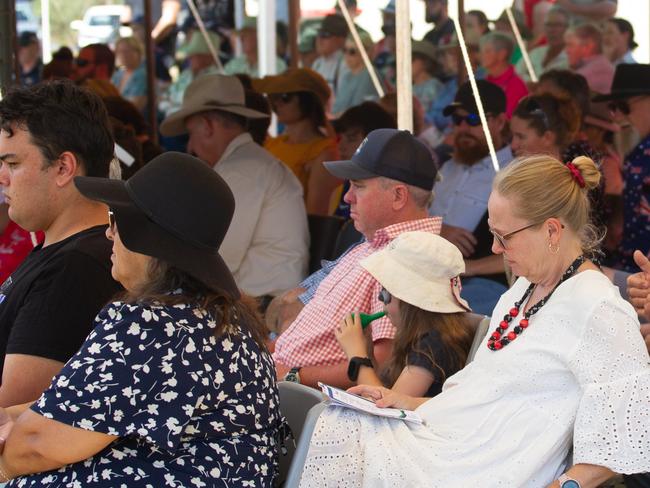 Guests sat under the cool shade of the tents during the hot summer day.