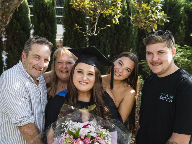 Bachelor of Nursing graduate Tayla Milne is congratulated by family (from left) Stuart Milne, Amanda Potter, Ciarn Milne and Cooper Gierke at a UniSQ graduation ceremony at Empire Theatres, Tuesday, October 31, 2023. Picture: Kevin Farmer