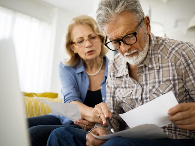 Shot of a senior couple looking stressed while going over their finances at home; wealth superannuation worries generic bills
