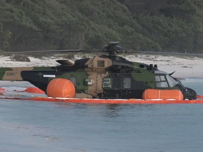 The MRH-90 Taipan helicopter is seen in shallow water on the beach after crashing off Jervis Bay. Picture: TNV