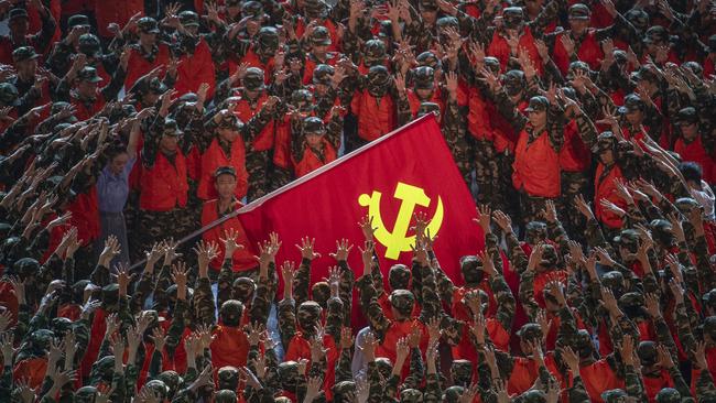 Massed performers appear to worship the Chinese Communist Party flag during celebrations in Beijing to mark the party’s centenary. Picture: Getty Images