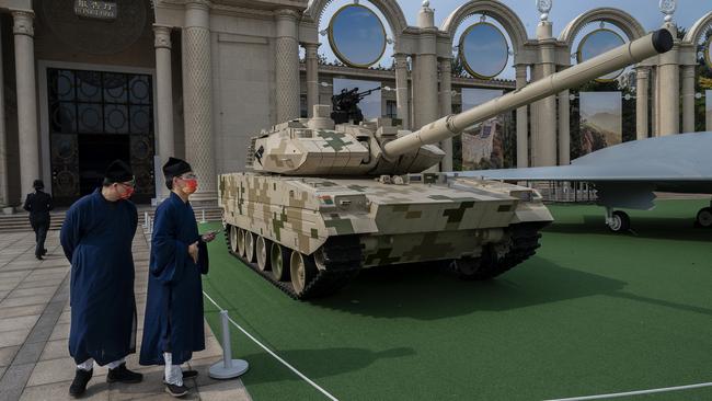 Party members look at a display of military hardware at an exhibition in Beijing highlighting Xi Jinping's years as leader. Picture: Getty Images