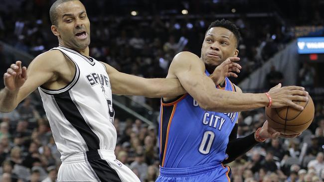Oklahoma City Thunder guard Russell Westbrook (0) drives to the basket against San Antonio Spurs guard Tony Parker.